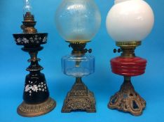 Three oil lamps on cast bases