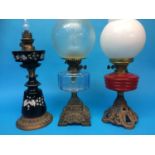 Three oil lamps on cast bases