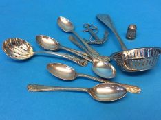 A Continental silver metal strainer and various spoons