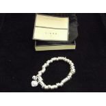 Silver, Links of London bracelet with two charms.