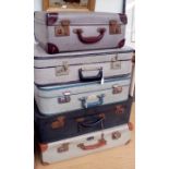Stack of five vintage suitcases