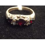 9ct gold dress ring with garnets and seed pearls.