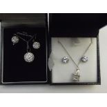 Two silver earring and necklace sets