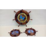 Three ships wheels inset with iridescent butterfly