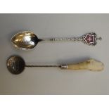 Kenyan silver spoon together with an enamelled sil