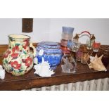A shelf of glass, ceramics and others