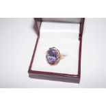 9 carat gold dress ring with large purple stone
