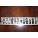 Collection of 12 wristwatches with display case