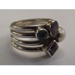 Silver ring set with various gemstones