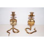 Pair of brass candlesticks in the form of hooded c