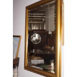 A large gold framed mirror