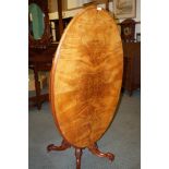 Victorian walnut tilt-top table on bulbous carved under cartridge, finally carved on original caster