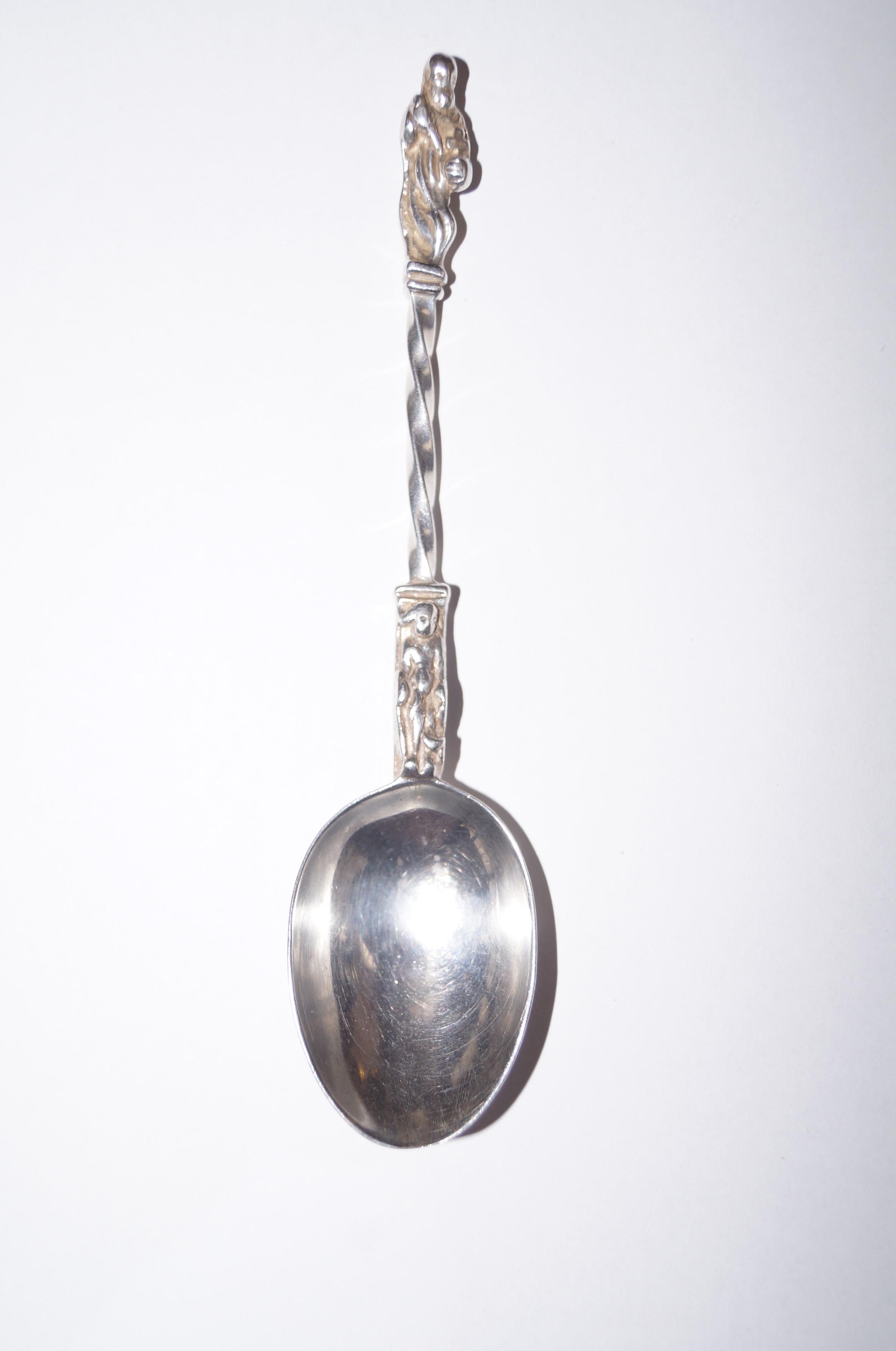 A silver hallmarked spoon with a religious figure