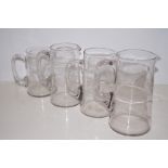 Four graduating Edwardian water jugs