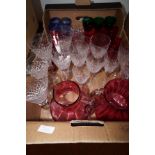 A box of Cranberry glass and other wine glasses