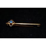 9ct gold pin brooch with single sapphire stone