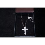 Silver cross and chain with white stones