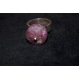 Silver ring set with large unpolished ruby