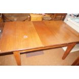 Extending dining table on casters