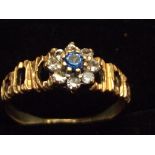 9ct Gold ring with central blue stone surrounded b