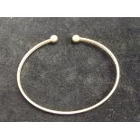 Yellow metal bangle, tested for gold. Weight 3.6 g