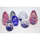 Seven glass paperweights