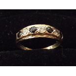 9ct gold ring set with 3 white and 3 black stones.