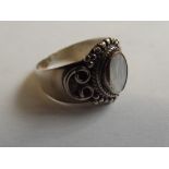 Silver dress ring with central hard stone
