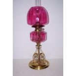 Arts and crafts style oil lamp with cranberry glas