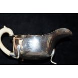 Silver sauce boat with ivory handle. Total weight