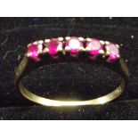 Yellow metal ring set with possible rubies. Size O