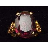 Yellow metal dress ring with large purple stone (a