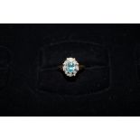 18ct Gold dress ring set with central blue gem sto