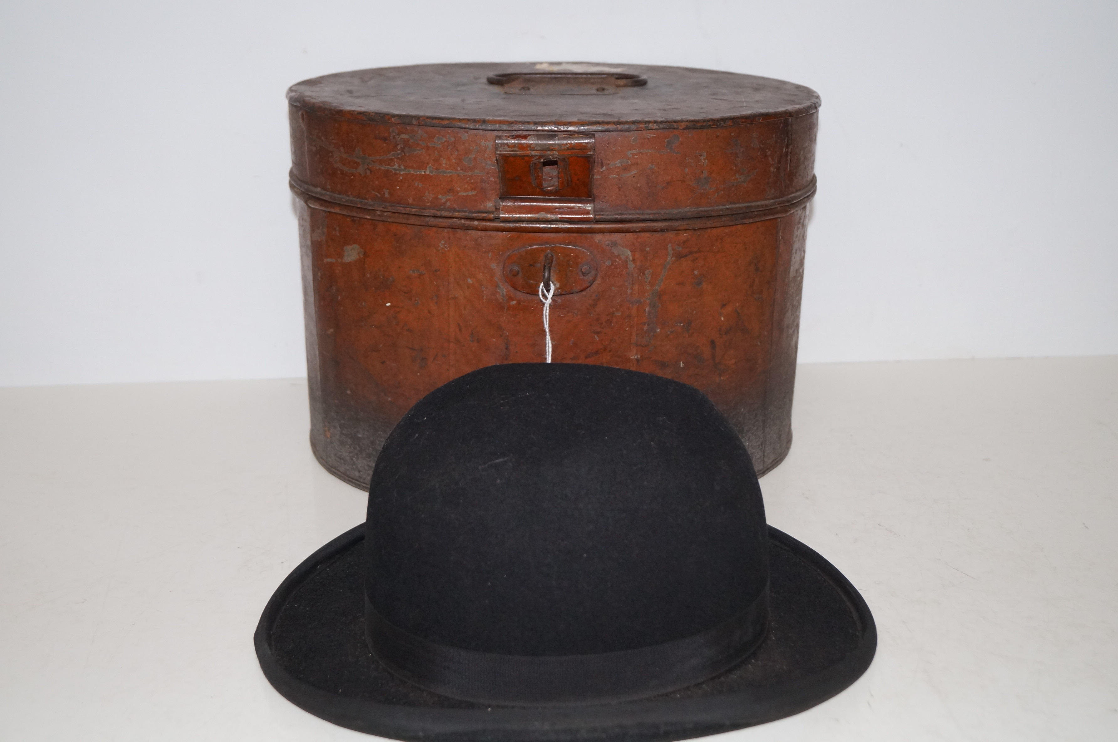 Victorian tin top hat box together with a bowler h