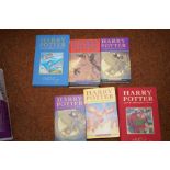 4 hard Back Harry Potter books and 2 paper back