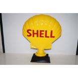 Large cast shell sign on plinth. Height 50cm