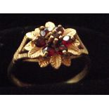 9ct Gold dress ring set with red stones in a flora