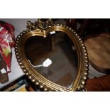 A guilt framed heart shaped mirror