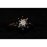 9ct gold ring set with small central diamond surro