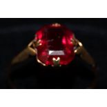 9ct gold dress ring set with large red stone. Size