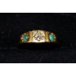 18ct gold ring set with central diamond with two g