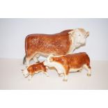 Three porcelain Hereford cattle