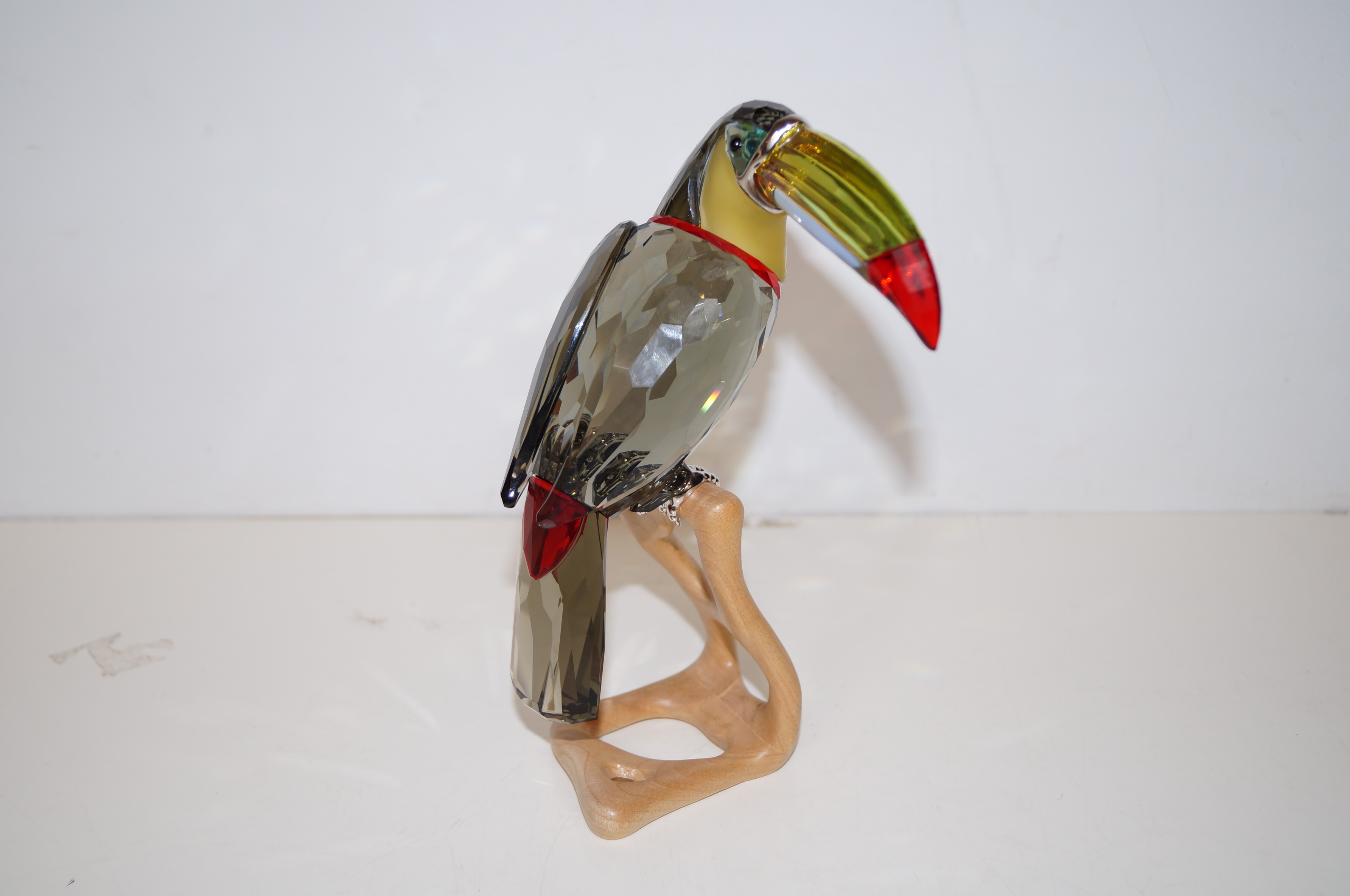 Swarovski "The Toucan Black Diamond" on a wooden b