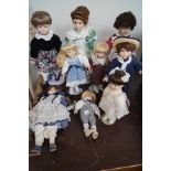 Collection of nine porcelain headed dolls