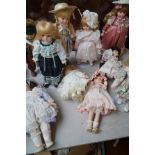 Collection of ten porcelain headed dolls