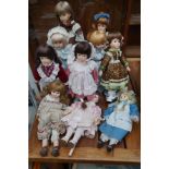 Collection of ten porcelain headed dolls