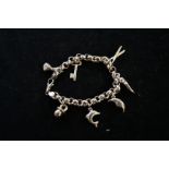 Silver charm bracelet with 7 charms. Weight 18.5 g