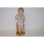 Bisque figure of a young boy. Height 33cm