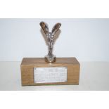 Spirit of Ecstasy mascot on wooden base with Rols