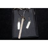 A silver necklace and earring set